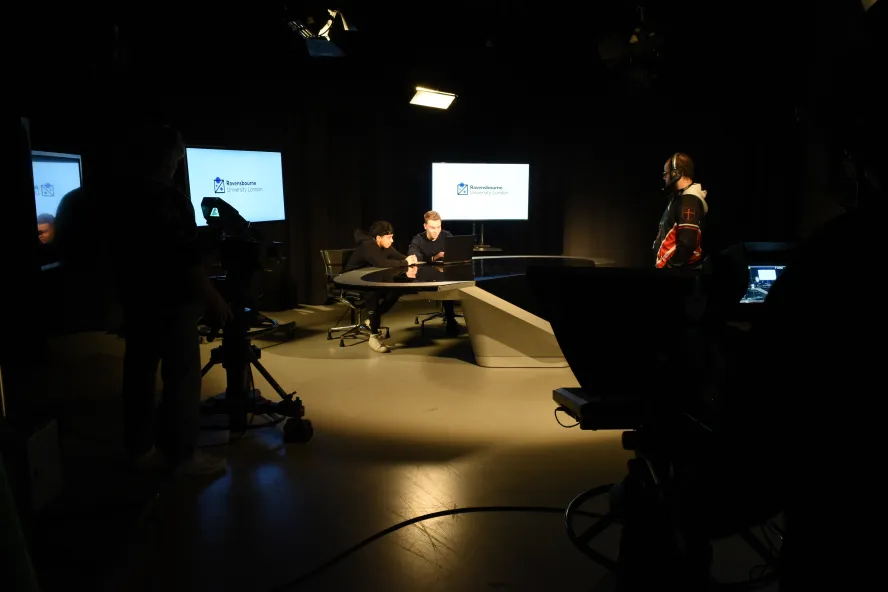 Students sitting in the broadcast studio.