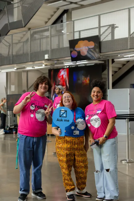students posing with signs