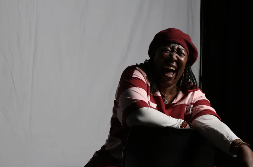 really smiley lady laughing sat on a chair