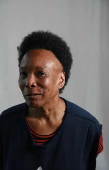 smiling black lady winks at the camera