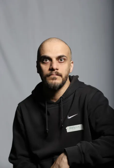 Portrait of a bald man staring directly at the camers