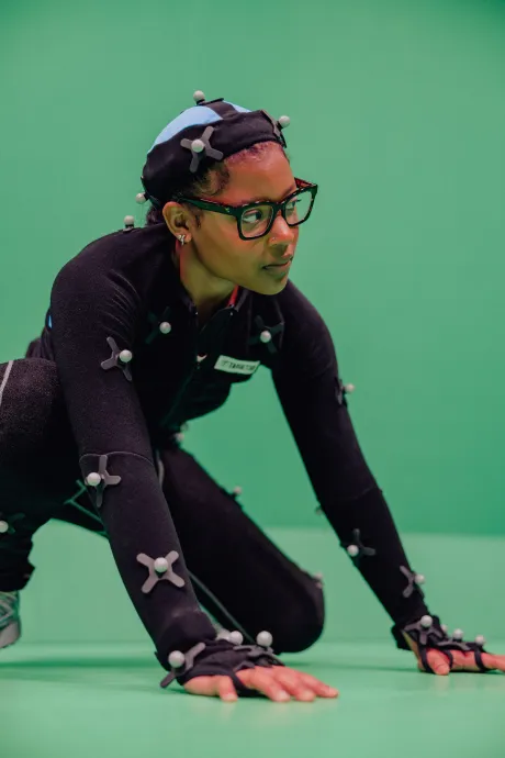 Student posing in a motion capture suit