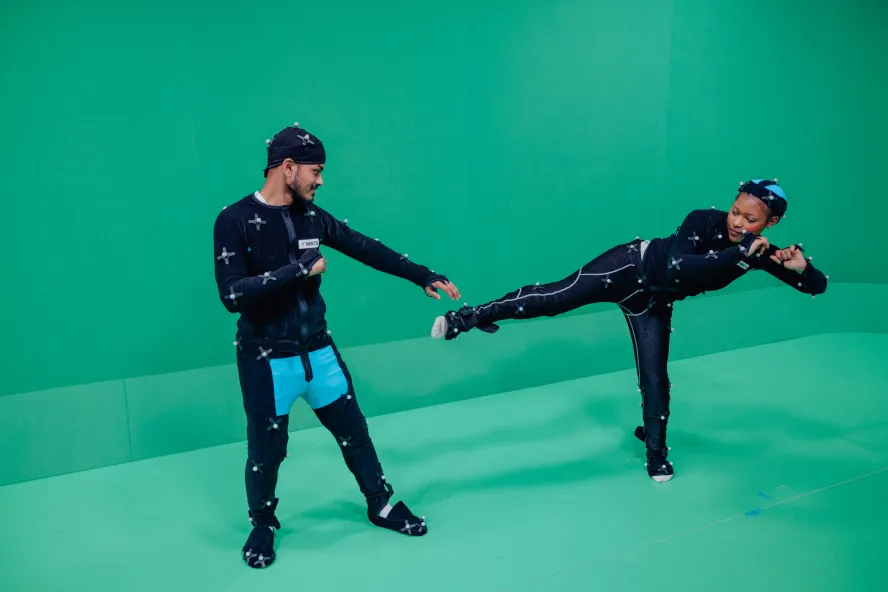 Student filming a fight scene in a motion capture suit