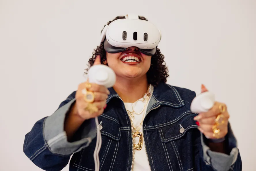 Student smiling whilst using the VR headset