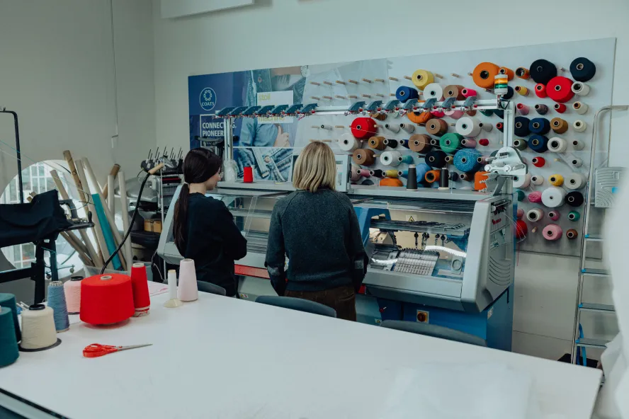 Students looking at equipment for sewing in the Atelier at Ravensbourne University London