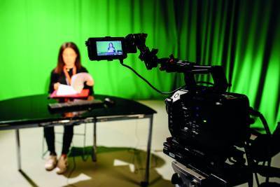 woman-sat-presenting-whilst-being-recorded-in-tv-studio