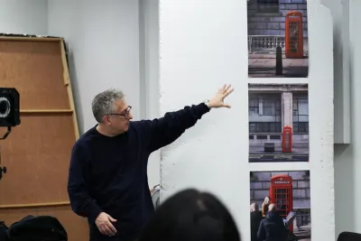 Course leader gives feedback to digital photography students