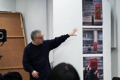 Course leader gives feedback to digital photography students