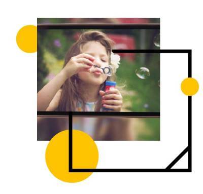 Young woman with long brown hair blowing bubbles