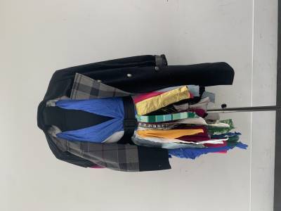 A mannequin with a garment made of multi coloured scraps of material on