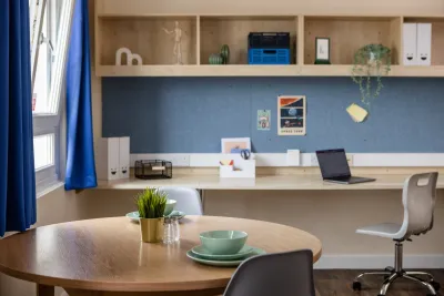 Gold Deluxe Studio room with table and chairs