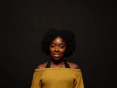 Young woman smiling wearing yellow top