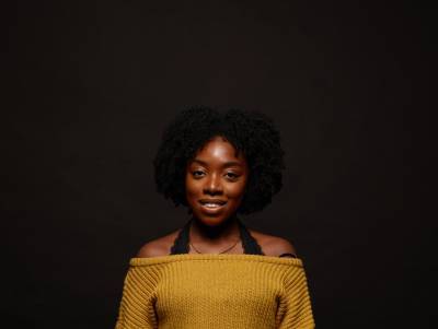 Young woman smiling wearing yellow top