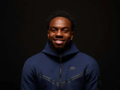 Young man smiling to the camera wearing a Nike Hoodie