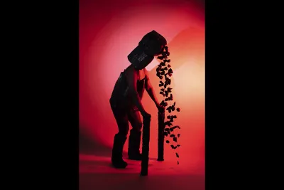 Person wearing a mask squating