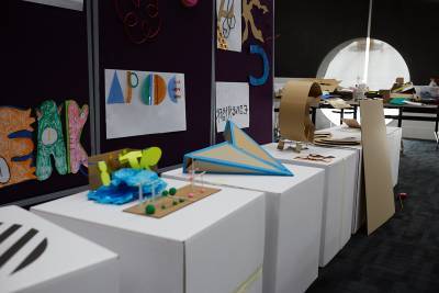 typography experiments and 3D sculptures displayed on large white boxes