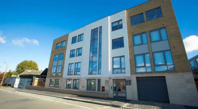 The Cube student accommodation building. A three story building with large windows.