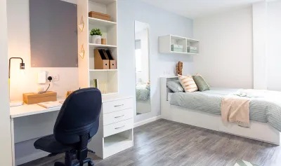 Bedroom with study area and bed.