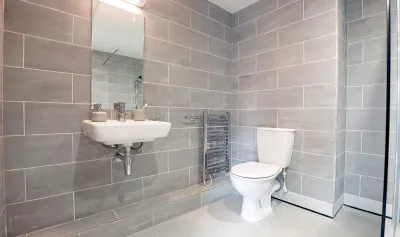 Tiled bathroom with toilet and sink