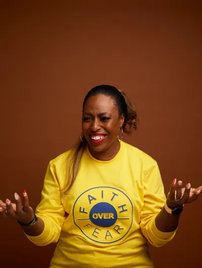 Ceewhy smiling at the camera wear sweat shirt with slogan 'Faith over Fear'