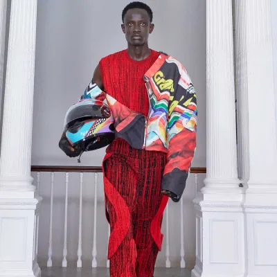 Model wearing red jumpsuit and colourful biker jacket