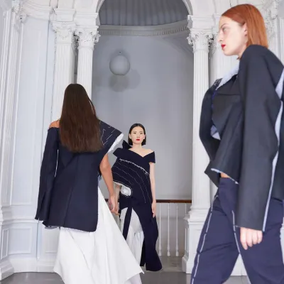 Models on the catwalk wearing denim off shoulder blazers