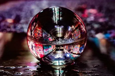 Glass globe reflecting a street view at night