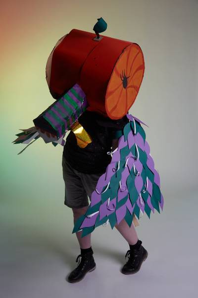 Large round duck with orange head and purple wings