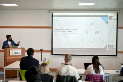 A photo of Ifran Ahmed giving a speech at Belfast University 