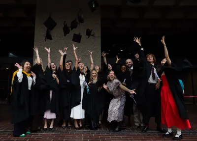 Graduates throwing mortarboards
