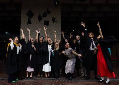 Graduates throwing mortarboards