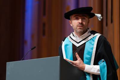 A man presenting on stage