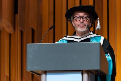 A man presenting on stage