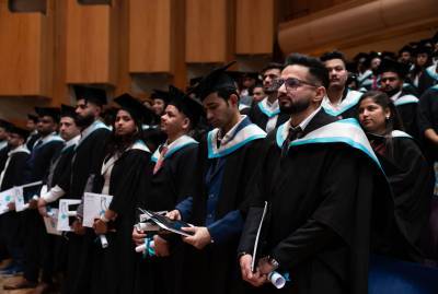 Several graduates at a ceremony