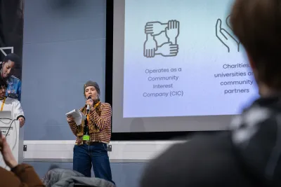 A person giving a talk to students
