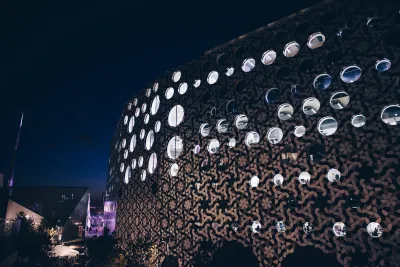 Ravensbourne R1 building with purple lighting at night time