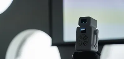 White robot on display with a teaching mode monitor as part of a display at Ravensbourne Degree Show