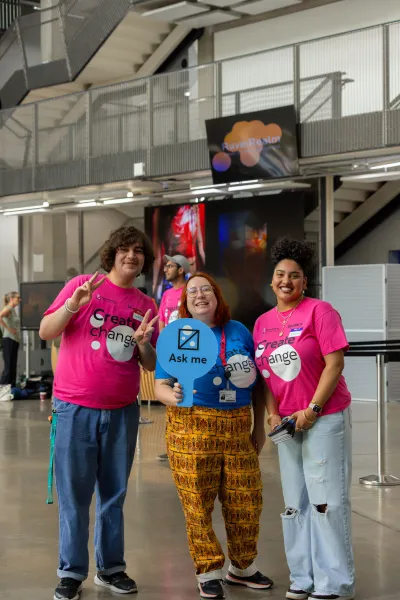 students posing with signs