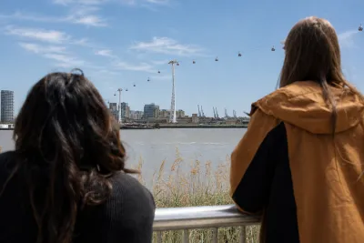 Students looking out to thames and cable cars