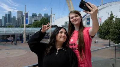 Students taking a selfie on the peninsula balcony